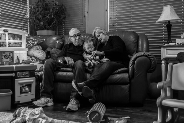 Grandma and Grandpa with baby on couch